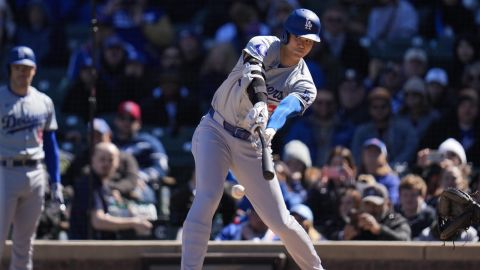 Los Angeles Dodgers' Shohei Ohtani hits the ball but is forced out a first by Chicago Cubs pitcher Kyle Hendricks during the third inning of a baseball game Friday, April 5, 2024, in Chicago. (AP Photo/Erin Hooley)