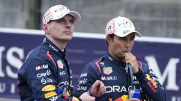 Pole position Red Bull driver Max Verstappen, left, of the Netherlands and teammate Sergio Perez of Mexico takes a break after the qualifying session at the Suzuka Circuit in Suzuka, central Japan, Saturday, April 6, 2024, ahead of Sunday's Japanese Formula One Grand Prix. (AP Photo/Hiro Komae)
