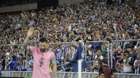 Fans use their mobile phones to take photos as Inter Miami's Lionel Messi takes a corner kick during a CONCACAF Champions Cup quarter final second leg soccer match against Monterrey at the BBVA stadium in Monterrey, Mexico, Wednesday, April 10, 2024. (AP Photo/Eduardo Verdugo)