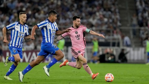 Inter Miami's Lionel Messi, right, tries control the ball past Monterrey's Luis Romo during a CONCACAF Champions Cup quarter final second leg soccer match at the BBVA stadium in Monterrey, Mexico, Wednesday, April 10, 2024. (AP Photo/Eduardo Verdugo)