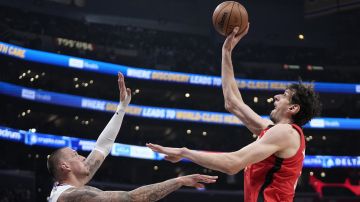 Houston Rockets center Boban Marjanovic, right, shoots as Los Angeles Clippers center Daniel Theis defends during the second half of an NBA basketball game Sunday, April 14, 2024, in Los Angeles. (AP Photo/Mark J. Terrill)