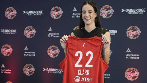 Indiana Fever's Caitlin Clark holds her jersey following a WNBA basketball news conference, Wednesday, April 17, 2024, in Indianapolis. (AP Photo/Darron Cummings)