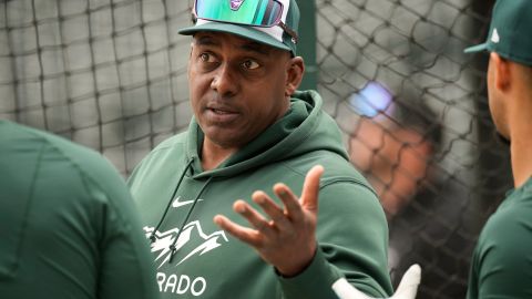 FILE - Colorado Rockies hitting coach Hensley Meulens chats with players as they warm up before a baseball game against the Philadelphia Phillies Saturday, May 13, 2023, in Denver. Federal aviation official said Friday, April 19, 2024, that they are investigating a video that appears to show Meulens sitting in the cockpit of a United Airlines charter flight while it was en route from Denver to Toronto on April 10. Unauthorized persons are not allowed onto aircraft flight decks under federal regulations. (AP Photo/David Zalubowski, File)