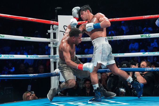 Ryan Garcia, right, knocks down Devin Haney during the 10th round of a super lightweight boxing match early Sunday, April 21, 2024, in New York. Garcia won the fight. (AP Photo/Frank Franklin II)