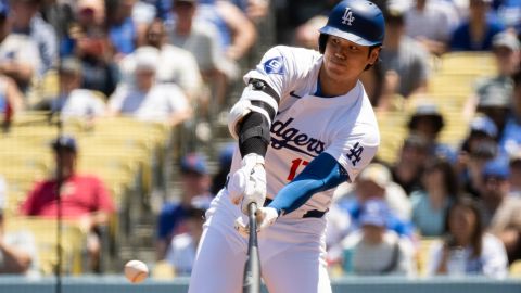 Los Angeles Dodgers' Shohei Ohtani bats during the first inning of a baseball game against the New York Mets in Los Angeles, Sunday, April 21, 2024. (AP Photo/Kyusung Gong)