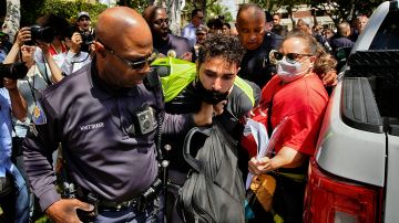 A University of Southern California protester is detained by USC Department of Public Safety officers during a pro-Palestinian occupation at the campus' Alumni Park on Wednesday, April 24, 2024, in Los Angeles. (AP Photo/Richard Vogel)