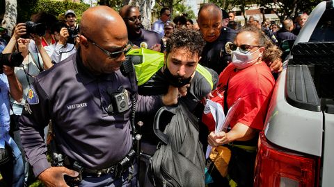 A University of Southern California protester is detained by USC Department of Public Safety officers during a pro-Palestinian occupation at the campus' Alumni Park on Wednesday, April 24, 2024, in Los Angeles. (AP Photo/Richard Vogel)