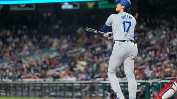 Los Angeles Dodgers designated hitter Shohei Ohtani watches his RBI double during the ninth inning of the team's baseball game against the Washington Nationals at Nationals Park, Wednesday, April 24, 2024, in Washington. The Dodgers won 11-2. (AP Photo/Alex Brandon)