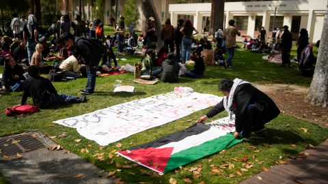 A student places a Palestinian flag on the ground on the USC campus Thursday, April 25, 2024, in Los Angeles. (AP Photo/Jae C. Hong)