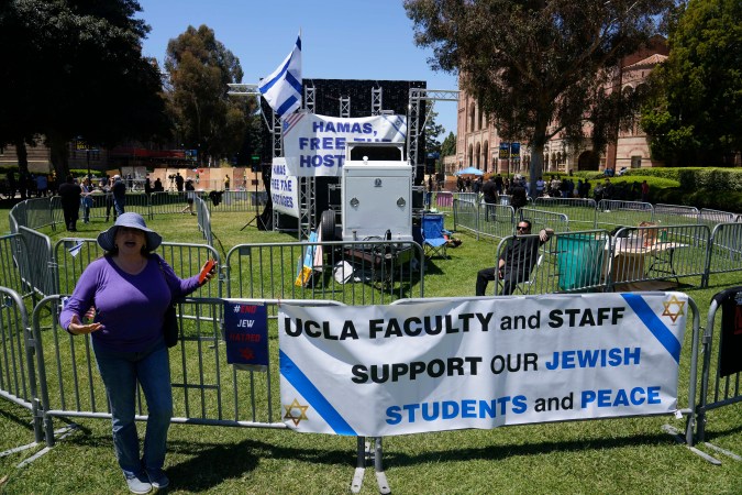 Signs are placed at an encampment staged to protest the Israel Hamas War on the UCLA campus, Monday, April 29, 2024, in Los Angeles. (AP Photo/Damian Dovarganes)