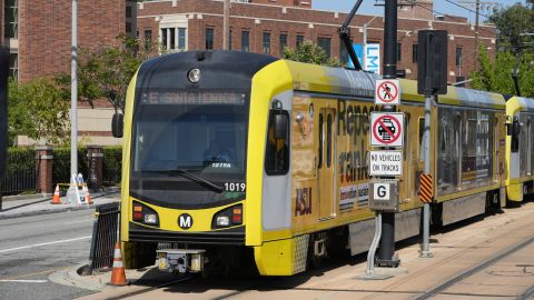 A Metro light rail train resumes service in Los Angeles, Tuesday, April 30, 2024. Officials say multiple people were hurt, and a few seriously, when a Metro light rail train and a University of Southern California shuttle bus collided in downtown Los Angeles. (AP Photo/Damian Dovarganes)