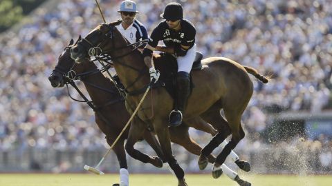 Ellerstina's Facundo Pieres, front right, hits the ball under pressure from La Dolfina's Adolfo Cambiaso at the 119th Argentine Polo Championship in Buenos Aires, Saturday, Dec. 8, 2012. (AP Photo/Natacha Pisarenko)