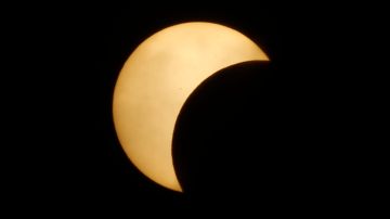 The moon is obscuring part of the sun during a solar eclipse in Phnom Penh, Cambodia, Wednesday, March 9, 2016. (AP Photo/Heng Sinith)