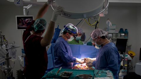 In this Thursday, Jan. 28, 2016 photo, Palestinian cardiovascular surgeon Saleem Haj-Yahia, left, performs open-heart surgery at An-Najah University hospital in the West Bank city of Nablus. Dr. Haj-Yahia is the first surgeon to perform a successful artificial heart transplant in the West Bank. (AP Photo/Majdi Mohammed)
