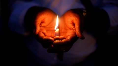 An Indian Christian holds a candle in solidarity with the victims of Sundays suicide attack on a church in Pakistan, outside the Sacred Heart Cathedral in New Delhi, India, Tuesday, Sept. 24, 2013. The attack left 85 people dead and more than 140 people wounded. It was the deadliest ever attack in Pakistan against members of the Christian faith. (AP Photo/Altaf Qadri)
