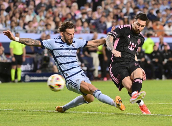 AME7473. KANSAS CITY (ESTADOS UNIDOS), 13/04/2024.- El mediocampista del Inter Miami Lionel Messi (10, derecha) dispara hacia la portería mientras el defensor del Sporting Kansas City Tim Leibold (14) intenta bloquear durante un partido de la MLS (Major League Soccer) entre Inter Miami y Sporting KC este sábado, en el estadio Arrowhead en Kansas City (EE.UU.). Inter Miami venció 3-2. EFE/ Tim Vizer