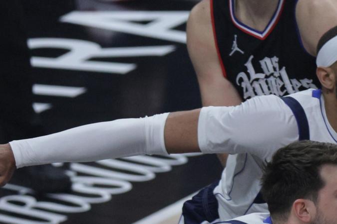 Kawhi Leonard (der,) es defendido por Luka Doncic, de los Mavericks, en duelo de estrellas durante el juego 2 de su serie de playoffs.