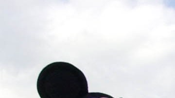 ** FILE ** Visitors gather in front of Cinderella's castle to watch Mickey and Minnie Mouse during the Christmas parade at Walt Disney World's Magic Kingdom in Lake Buena Vista, Fla, Dec. 22, 2004. A group of seven friends from Sydney _ all Disney fanatics organized a 32-day trip that takes them to every Disney park in the world _ from Tokyo to Hong Kong to Paris, to the U.S. flagships, Disneyland in Anaheim, Calif., and Walt Disney World near Orlando, Fla. (AP Photo/Peter Cosgrove)