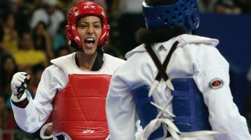 Mexico's Iridia Salazar, left, reacts during the fight against Cuba's Yaimara Rosario, right, during the tae kwondo women's 57kg semifinal at the XV Pan American Games in Rio de Janeiro, Sunday, July 15, 2007. Salazar won the fight and went on to win gold. (AP Photo/Victor R. Caivano)