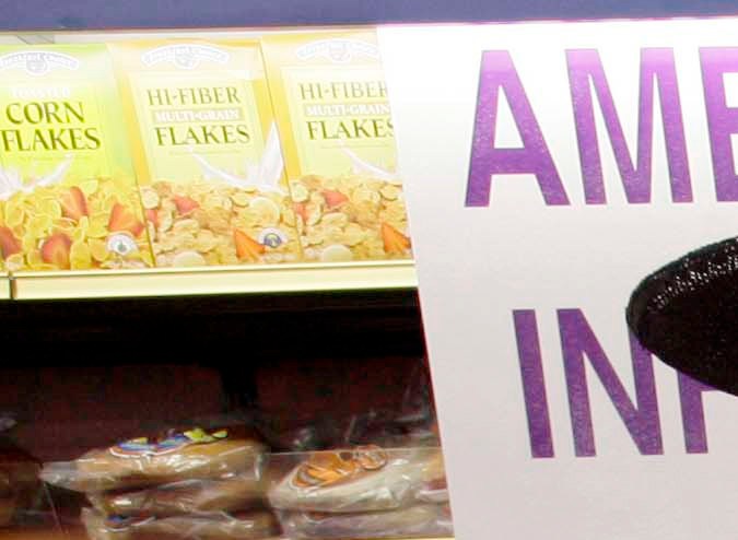 Jacques Elsair shops at the 99 cent Only store in Los Angeles Monday, Sept 8, 2008. The discount retailer announced Monday the first price increase in the chain's 26-year history by raising the cost of household items, food and other items by almost a penny. The company blamed rising inflation, food and energy prices for the new 99.99 cent price. (AP Photo/Nick Ut)