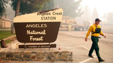 A firefighter walks to his vehicle as they battle the Station fire burning in the Angeles National Forest northeast of downtown Los Angeles on Firday, Aug. 28, 2009. The Los Angles Sheriff's Department says a voluntary evacuation is being urged for nearly 900 homes in the La Canada Flintridge area. (AP Photo/Jason Redmond)