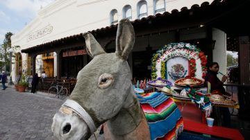 In this March 3, 2011 photo, a toy burro used for Mexican traditional tourist's photos waits for customers at El Pueblo de Los Angeles Historic District. The district has become a battleground over claims to the area's past and future as a cluster of disputes swirl around the shops, adobe buildings and Mexican-era churches in the city's historic birthplace. (AP Photo/Damian Dovarganes)