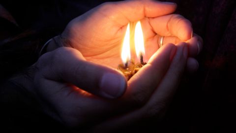 People light candles during a commemoration ceremony for victims of the 1932-33 Great Famine in Kiev, Ukraine, Saturday, Nov. 26, 2011. Church bells tolled, candles flickered and national flags, adorned with black ribbons, flew in the Ukrainian capital Kiev Saturday as the country marked the anniversary of the start of a Soviet-era famine that killed millions. (AP Photo/Efrem Lukatsky)