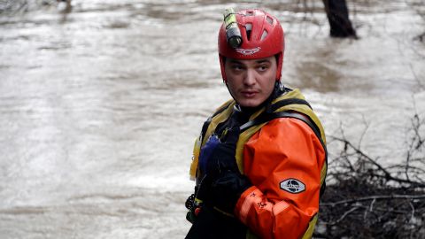 A San Jose Fire Dept. firefighter monitors a overflowing creek as rescues are underway Tuesday, Feb. 21, 2017, in San Jose, Calif. Rescuers chest-deep in water steered boats carrying dozens of people, some with babies and pets, from a San Jose neighborhood inundated by water from an overflowing creek Tuesday. (AP Photo/Marcio Jose Sanchez)