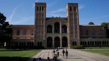 Students walk past Royce Hall at the University of California, Los Angeles Thursday, April 25, 2019, in the Westwood section of Los Angeles. Hundreds of students and staff at two Los Angeles universities, including UCLA, have been placed under quarantine because they may have been exposed to measles. Officials say the people affected by the order either have not been vaccinated or cannot verify that they are immune. (AP Photo/Jae C. Hong)