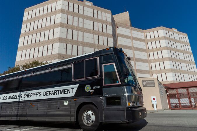 FILE - In this April 1, 2020 file photo a Los Angeles County Sheriff's Department prisoner transportation bus leaves the Twin Towers Correctional Facility in Los Angeles. California Gov. Gavin Newsom has pardoned 13 former prisoners, including three whose immigration status may benefit. He also commuted the sentences of 21 current inmates on Friday, June 26, 2020 including several who killed their victims and had been serving life-without-parole sentences. (AP Photo/Damian Dovarganes, File)