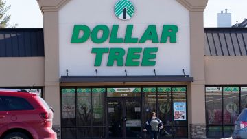This Thursday, Feb. 25, 2021, photo shows a woman leaving a Dollar Tree store in Urbandale, Iowa. (AP Photo/Charlie Neibergall)