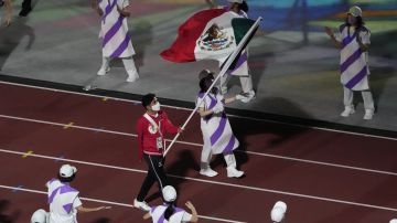 The flag of Mexico is carried into the stadium during the closing ceremony for the 2020 Paralympics at the National Stadium in Tokyo, Sunday, Sept. 5, 2021. (AP Photo/Eugene Hoshiko)