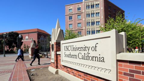 FILE - This March 12, 2019, file photo shows the University Village area of the University of Southern California, in Los Angeles. The first trial in the "Operation Varsity Blues" college admissions bribery scandal will begin this week, Wednesday, Sept. 8, 2021, with the potential to shed light on investigators' tactics and brighten the spotlight on a secretive school selection process many have long complained is rigged to favor the rich. (AP Photo/Reed Saxon, File)