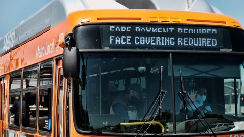 A Los Angeles Metro bus with an electronic display requiring a face mask is seen as the driver pulls out of a bus stop in Los Angeles on Tuesday, April 19, 2022. A federal judge's decision to strike down a national mask mandate was met with cheers on some airplanes but also concern about whether it's really time to end the order sparked by the COVID-19 pandemic. (AP Photo/Richard Vogel)