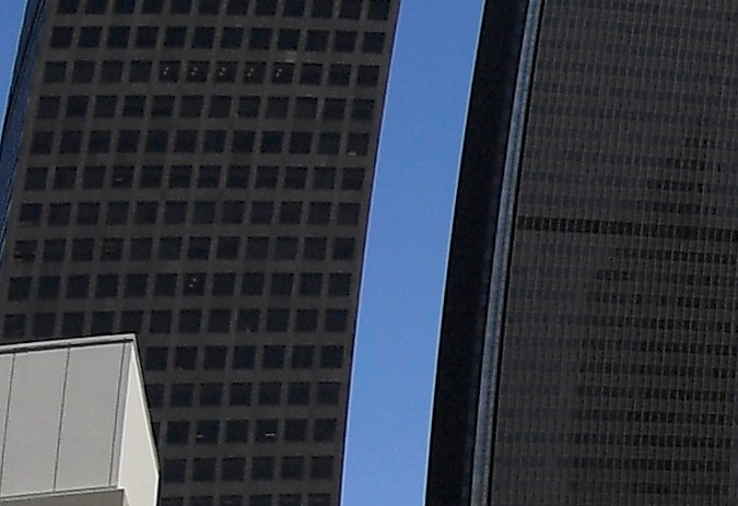 FILE - This May 21, 2020, file photo shows a homeless encampment on Beaudry Avenue as traffic moves along Interstate 110 below during the coronavirus outbreak, in downtown Los Angeles. The leader of a Los Angeles homeless agency announced her resignation Monday, April 25, 2022, amid a dispute with the organization's board over her efforts to increase the minimum pay level for staff. (AP Photo/Mark J. Terrill,File)