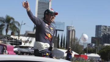 Mexican Formula One Red Bull driver Sergio "Checo" Perez waves before an exhibition race in the streets of Guadalajara, Mexico, Tuesday, Oct. 25, 2022. Perez will compete in the upcoming Mexico Grand Prix in Mexico City. (AP Photo)