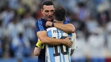 Argentina's head coach Lionel Scaloni embraces Argentina's Lionel Messi at the end of the World Cup quarterfinal soccer match between the Netherlands and Argentina, at the Lusail Stadium in Lusail, Qatar, Saturday, Dec. 10, 2022. (AP Photo/Natacha Pisarenko)