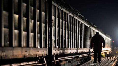 A railway worker walks by a Turkey-bound train loaded with emergency aid for building shelters from RescEU, at a railway station outside Bucharest, Romania, Saturday, Feb. 11, 2023. Humanitarian groups working in southern Turkey and northwest Syria warn that Monday's earthquake will have a "long tail" — a wide range of needs that will require donations for months, or even years, after the rescue and recovery missions end. (AP Photo/Andreea Alexandru)