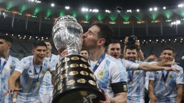 FILE - Argentina's Lionel Messi kisses the trophy after beating Brazil 1-0 in the Copa America final soccer match at Maracana stadium in Rio de Janeiro, Brazil, Saturday, July 10, 2021. Lionel Messi says he is coming to Inter Miami and joining Major League Soccer. After months of speculation, Messi announced his decision Wednesday, June 7, 2023,to join a Miami franchise that has been led by another global soccer icon in David Beckham since its inception but has yet to make any real splashes on the field. (AP Photo/Bruna Prado, File)