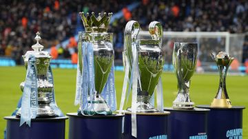 Trophies are displayed before the English Premier League soccer match between Manchester City and Sheffield United at the Etihad stadium in Manchester, England, Saturday, Dec. 30, 2023. (AP Photo/Dave Thompson)