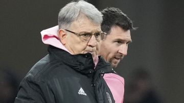 Inter Miami's head coach Gerardo "Tata" Martino, left, stands with forward Lionel Messi during the friendly soccer match between Vissel Kobe and Inter Miami CF at the National Stadium, Wednesday, Feb. 7, 2024, in Tokyo, Japan. (AP Photo/Eugene Hoshiko)