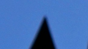 A young woman rides an electric scooter as the sun comes out and a rainbow appears in the sky following a spring rain shower, in Lisbon, Tuesday, March 26, 2024. (AP Photo/Armando Franca)