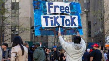 A man carries a Free TikTok sign in front of the courthouse where the hush-money trial of Donald Trump got underway Monday, April 15, 2024, in New York. (AP Photo/Ted Shaffrey)