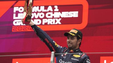 Third placed Red Bull driver Sergio Perez of Mexico celebrates on the podium after the Chinese Formula One Grand Prix at the Shanghai International Circuit, Shanghai, China, Sunday, April 21, 2024. (AP Photo/Andy Wong)