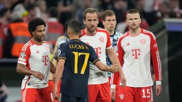Bayern Munich and Real Madrid players greet each other at the end of the Champions League semifinal first leg soccer match between Bayern Munich and Real Madrid at the Allianz Arena in Munich, Germany, Tuesday, April 30, 2024. (AP Photo/Matthias Schrader)