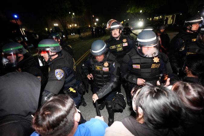 Police advance on demonstrators on the UCLA campus Thursday, May 2, 2024, in Los Angeles. (AP Photo/Ryan Sun)