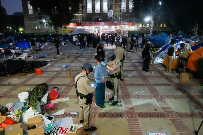 Pro-Palestinian demonstrators are detained on the UCLA campus Thursday, May 2, 2024, in Los Angeles. (AP Photo/Jae C. Hong)