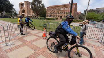 Security ride their bicycles around steel barriers blocking public access around Royce Hall area of the UCLA campus in Los Angeles on Friday, May 3, 2024. More than 2,400 people have been arrested during pro-Palestinian demonstrations since April 17. (AP Photo/Damian Dovarganes)