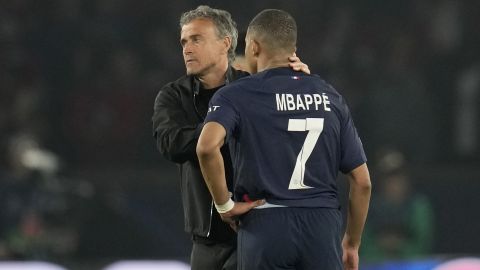 PSG's head coach Luis Enrique, left, comforts PSG's Kylian Mbappe after the Champions League semifinal second leg soccer match between Paris Saint-Germain and Borussia Dortmund at the Parc des Princes stadium in Paris, France, Tuesday, May 7, 2024. (AP Photo/Christophe Ena)