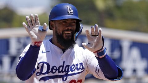 Los Angeles Dodgers' Teoscar Hernández gestures to teammates in the dugout as he rounds third after hitting a two-run home run during the sixth inning of a baseball game against the Miami Marlins Wednesday, May 8, 2024, in Los Angeles. (AP Photo/Mark J. Terrill)